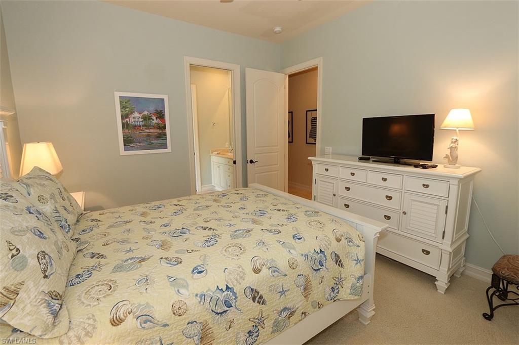 1824 Crayton Road Naples, FL 34102 - Photo 26 of 37 a bedroom with a bed and a flat screen tv