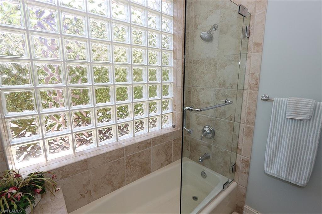 1824 Crayton Road Naples, FL 34102 - Photo 28 of 37 a bathroom with a bathtub and shower