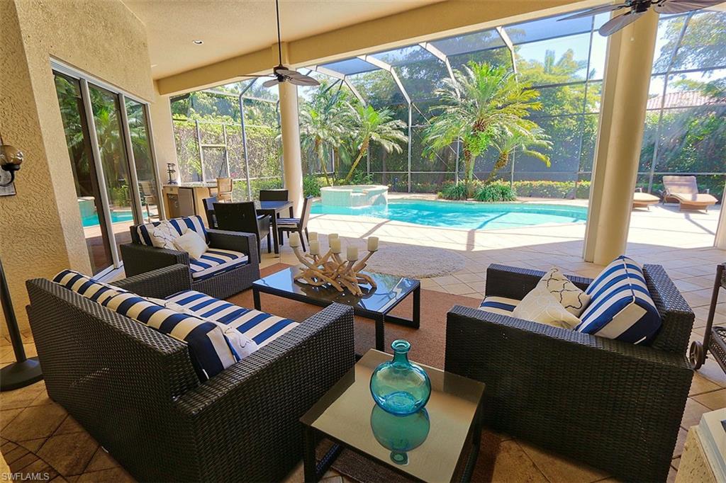 1824 Crayton Road Naples, FL 34102 - Photo 29 of 37 a living room with patio furniture and a floor to ceiling window