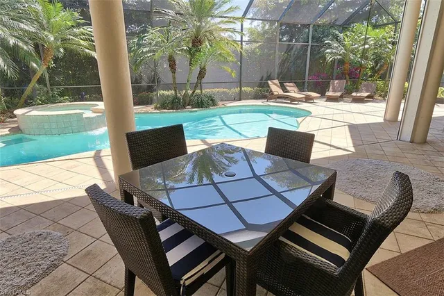 a view of a patio with table and chairs