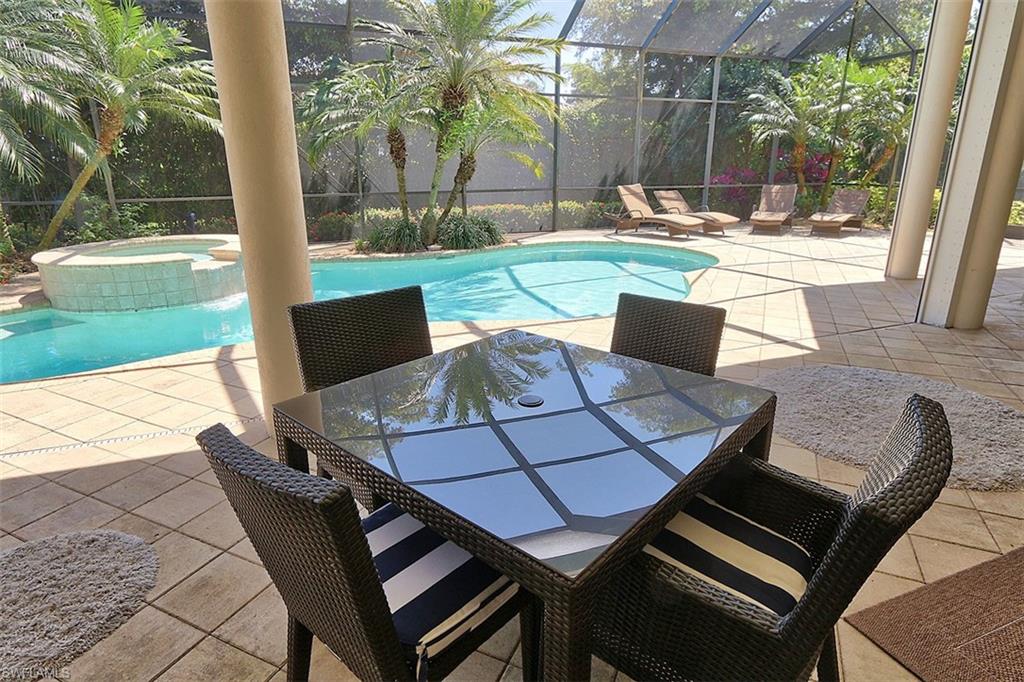 1824 Crayton Road Naples, FL 34102 - Photo 36 of 37 a view of a patio with table and chairs