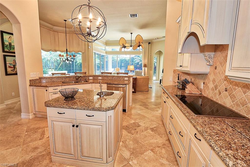 1824 Crayton Road Naples, FL 34102 - Photo 6 of 37 a kitchen with stainless steel appliances granite countertop a stove a sink and a wooden floors