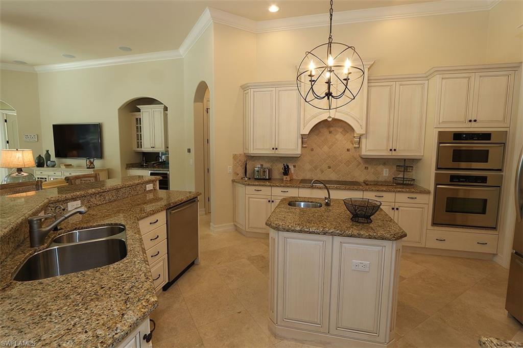 1824 Crayton Road Naples, FL 34102 - Photo 7 of 37 a kitchen with stainless steel appliances granite countertop a sink and a stove