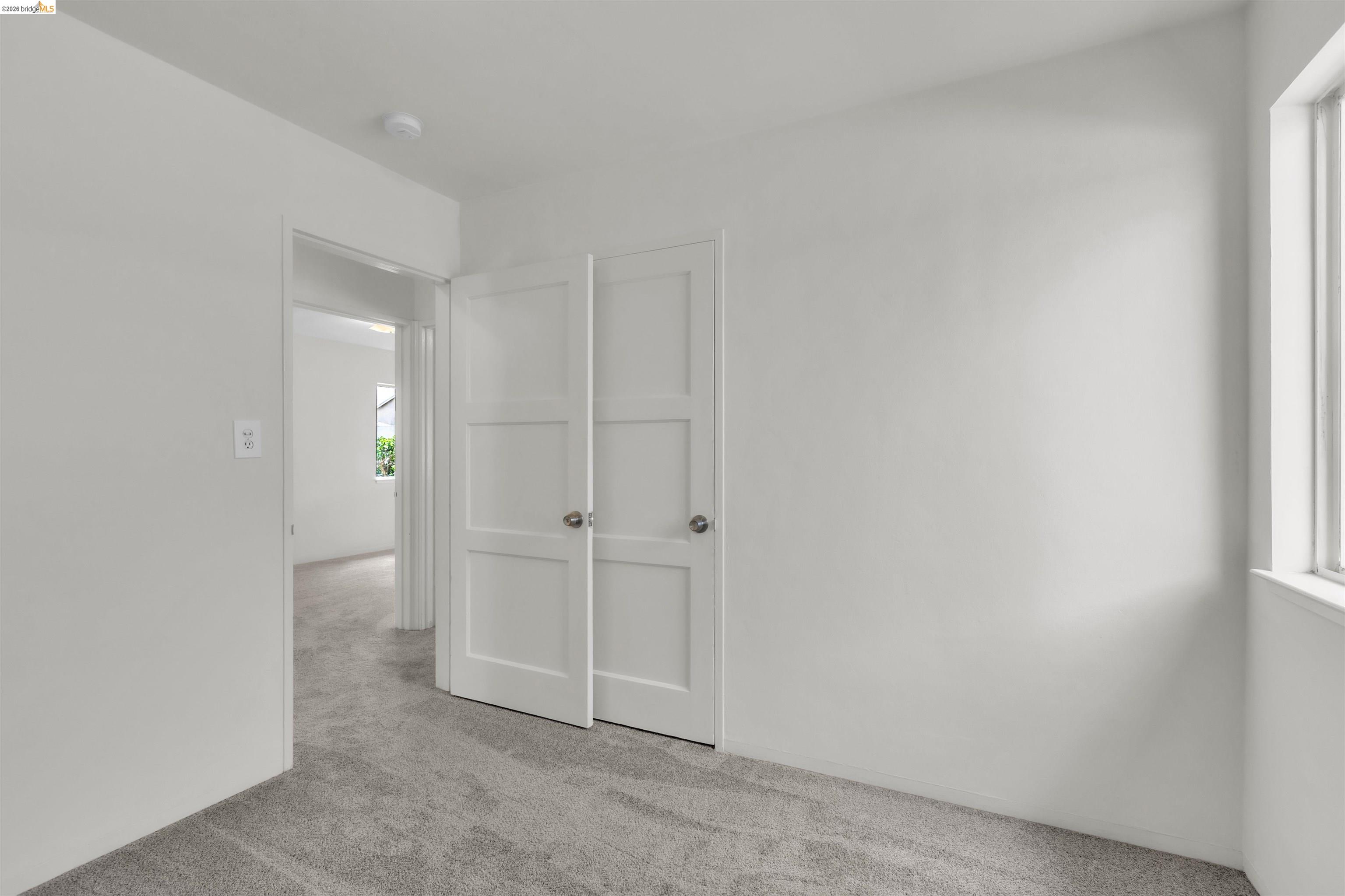 621 Paseo Del Rio San Lorenzo, CA 94580 - Photo 16 of 24 Spacious room featuring light gray carpeting, neutral wall finishes, and a multi-pane window