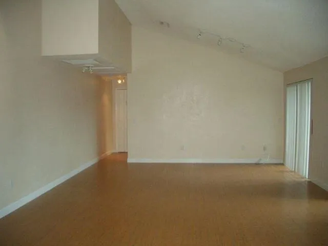 a view of a backyard with wooden fence
