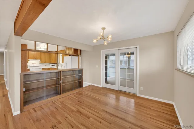 a room with wooden floor and window