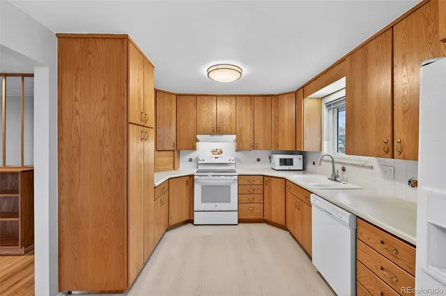 a kitchen with a sink stove and refrigerator