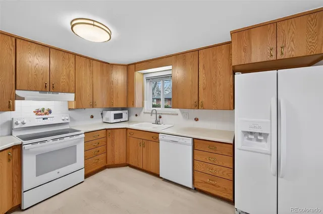 a kitchen with refrigerator and cabinets