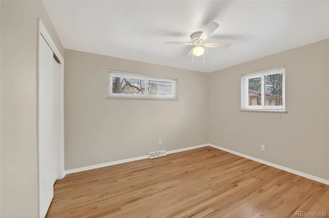 a view of an empty room with wooden floor