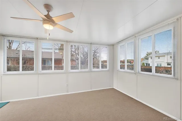 a view of an empty room with furniture and staircase