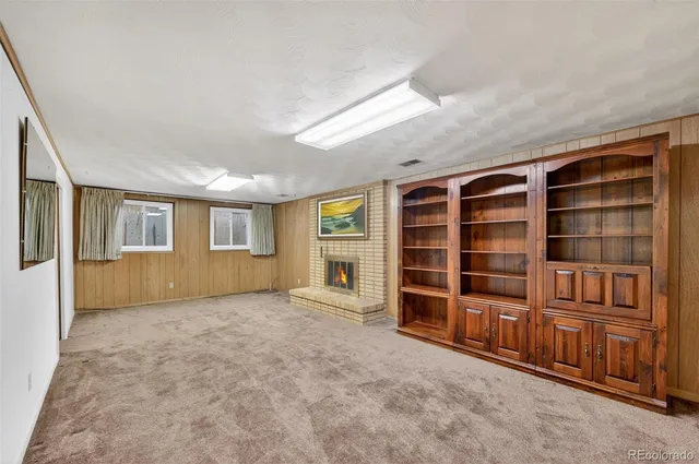 an empty room with a window and closet