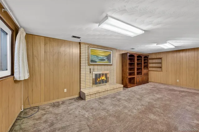 an empty room with closet and mirror