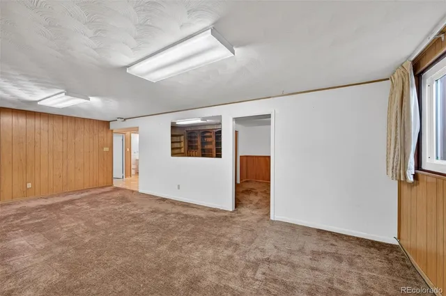 a view of a room with wooden floor and bathroom