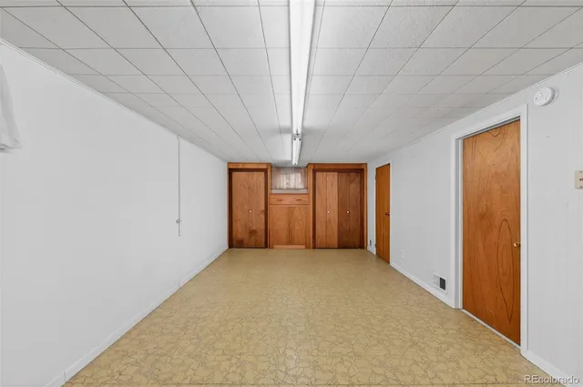 a view of an empty room with a staircase