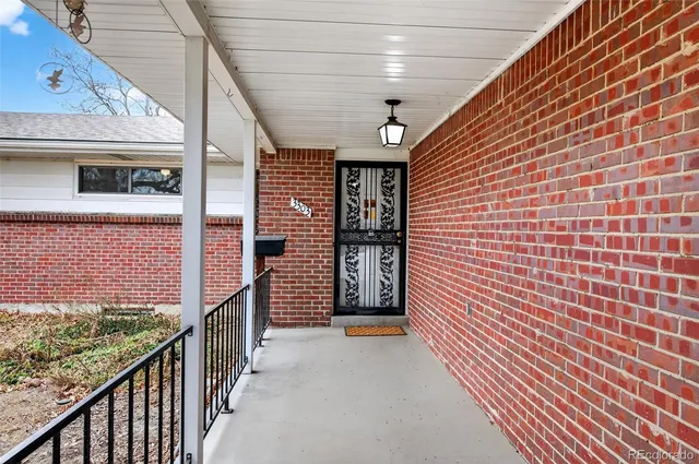 a view of a brick house with wooden stairs