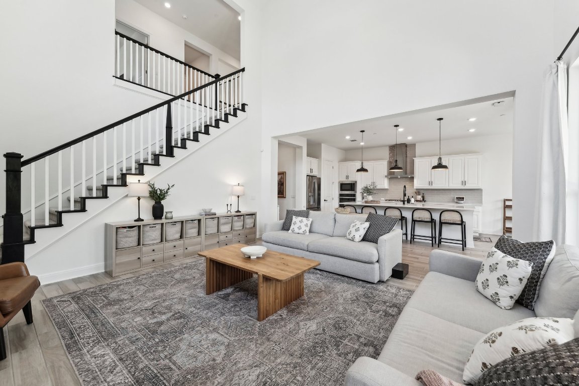 a living room with furniture and a dining table
