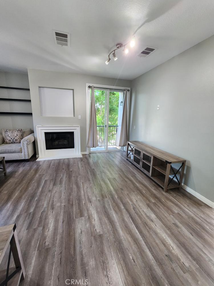 11040 Encanto Way El Monte, CA 91731 - Photo 5 of 17 wooden floor in an empty room with a fireplace