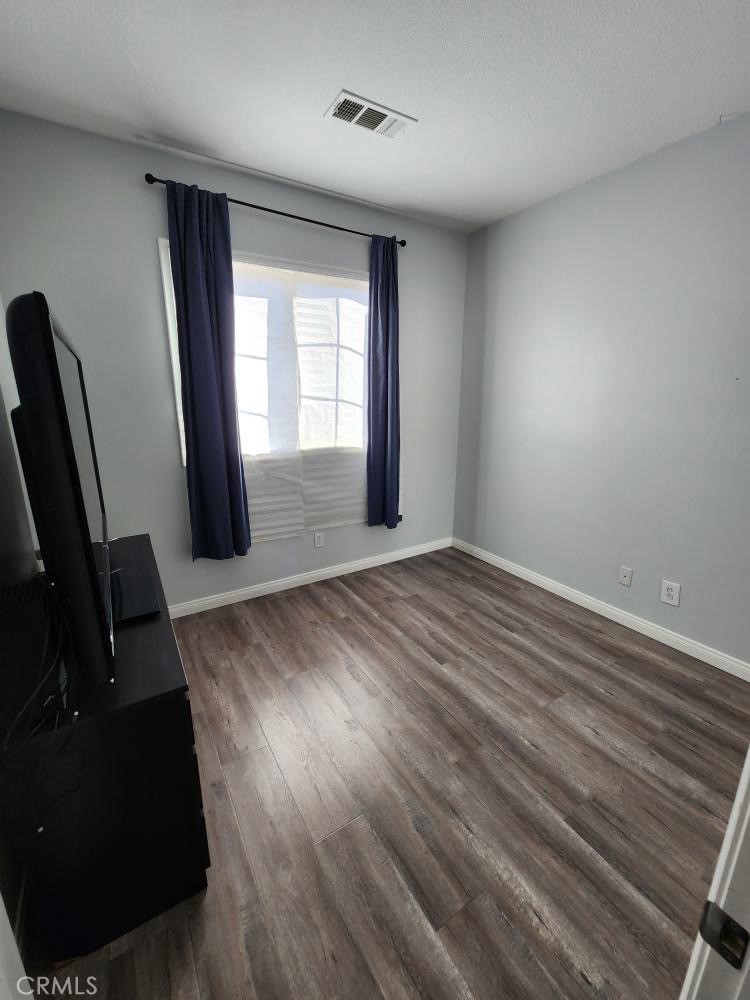 11040 Encanto Way El Monte, CA 91731 - Photo 9 of 17 wooden floor in an empty room with a window