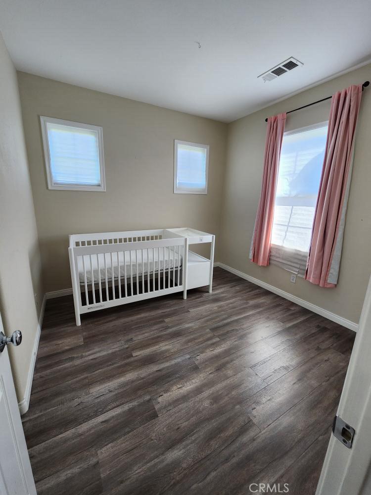 11040 Encanto Way El Monte, CA 91731 - Photo 10 of 17 a view of an empty room with wooden floor and a window