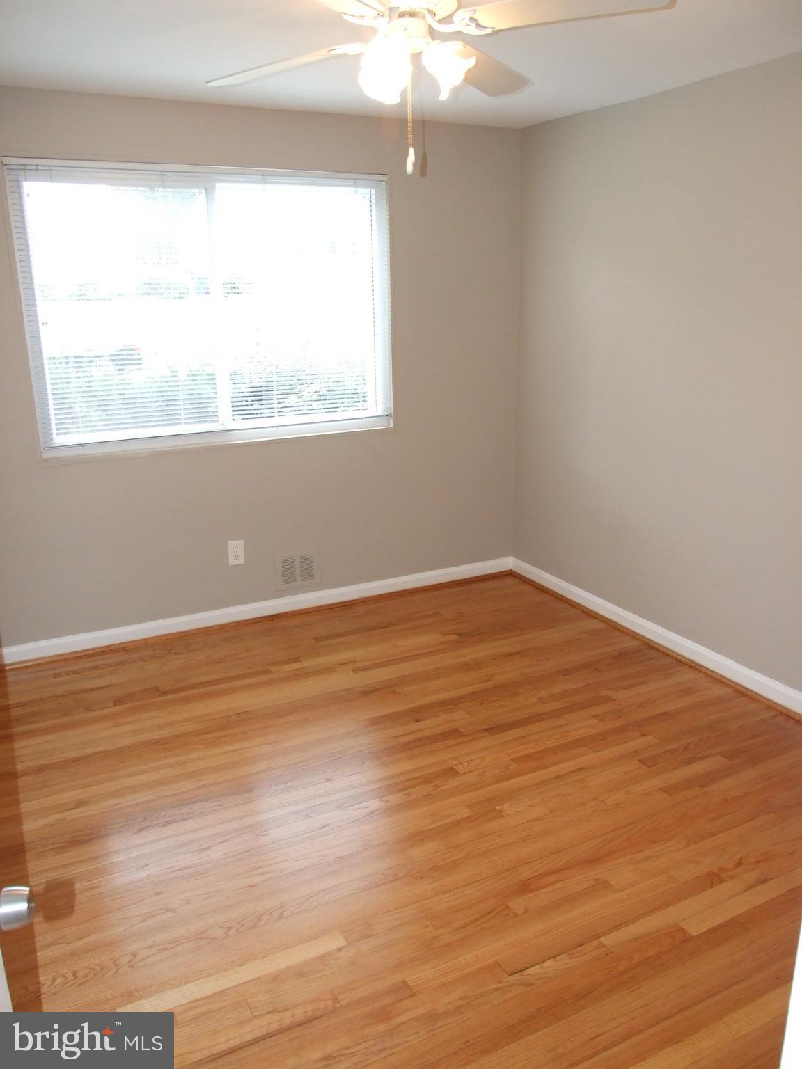 2941 Terrace Drive Chevy Chase, MD 20815 - Photo 13 of 24 a view of an empty room with wooden floor and a window