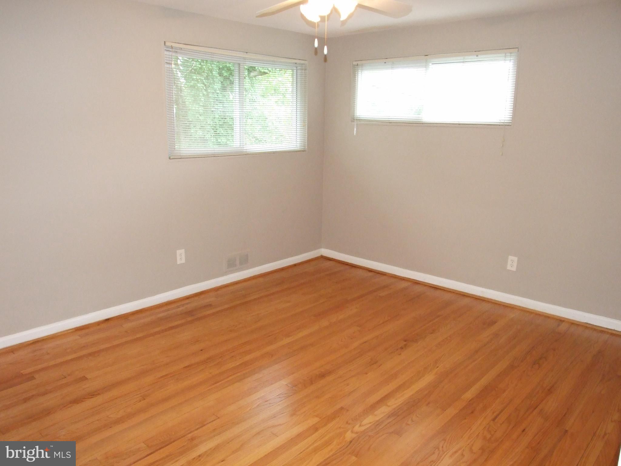 2941 Terrace Drive Chevy Chase, MD 20815 - Photo 14 of 24 an empty room with wooden floor and windows