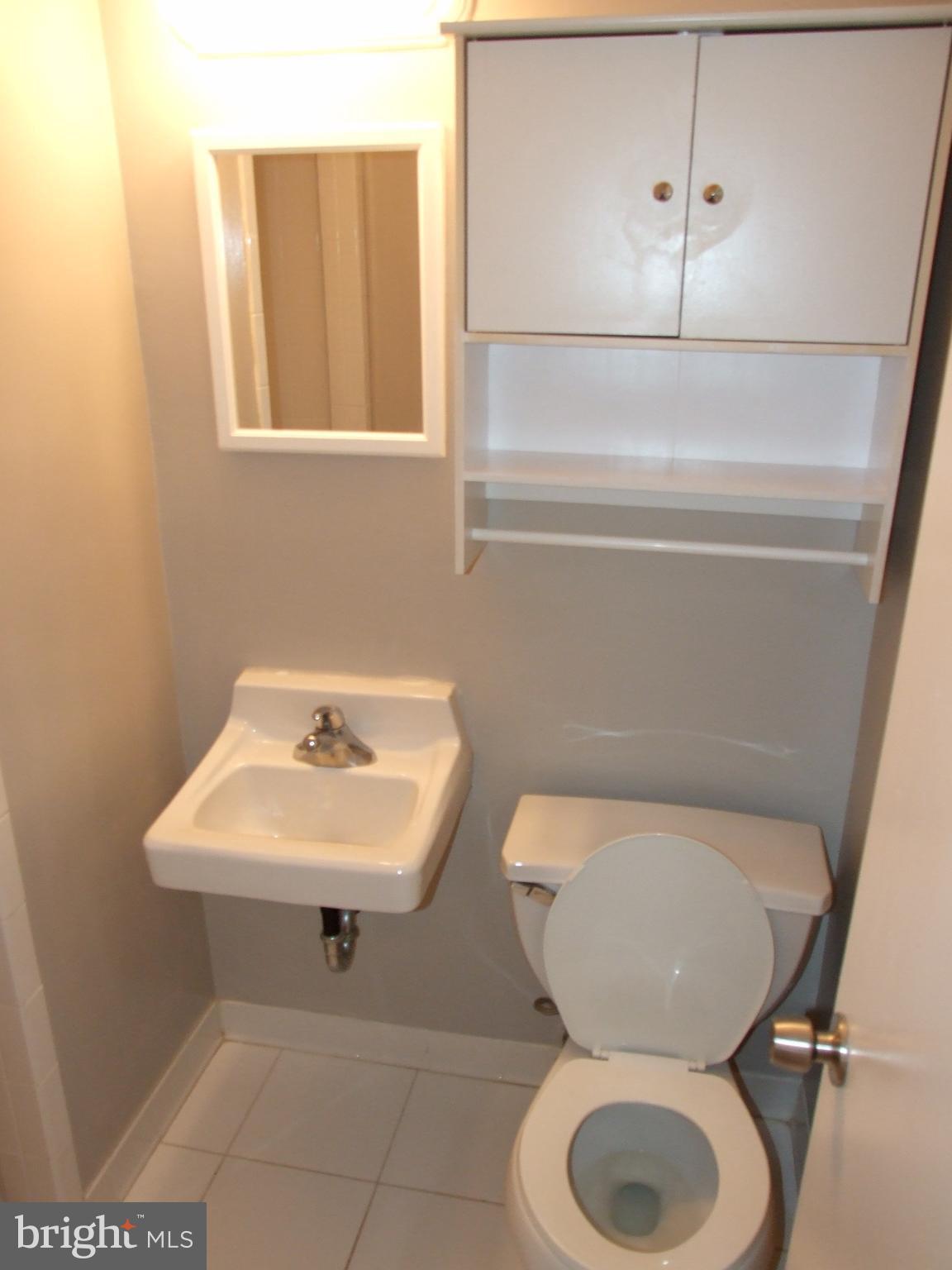 2941 Terrace Drive Chevy Chase, MD 20815 - Photo 15 of 24 a bathroom with a toilet sink and mirror