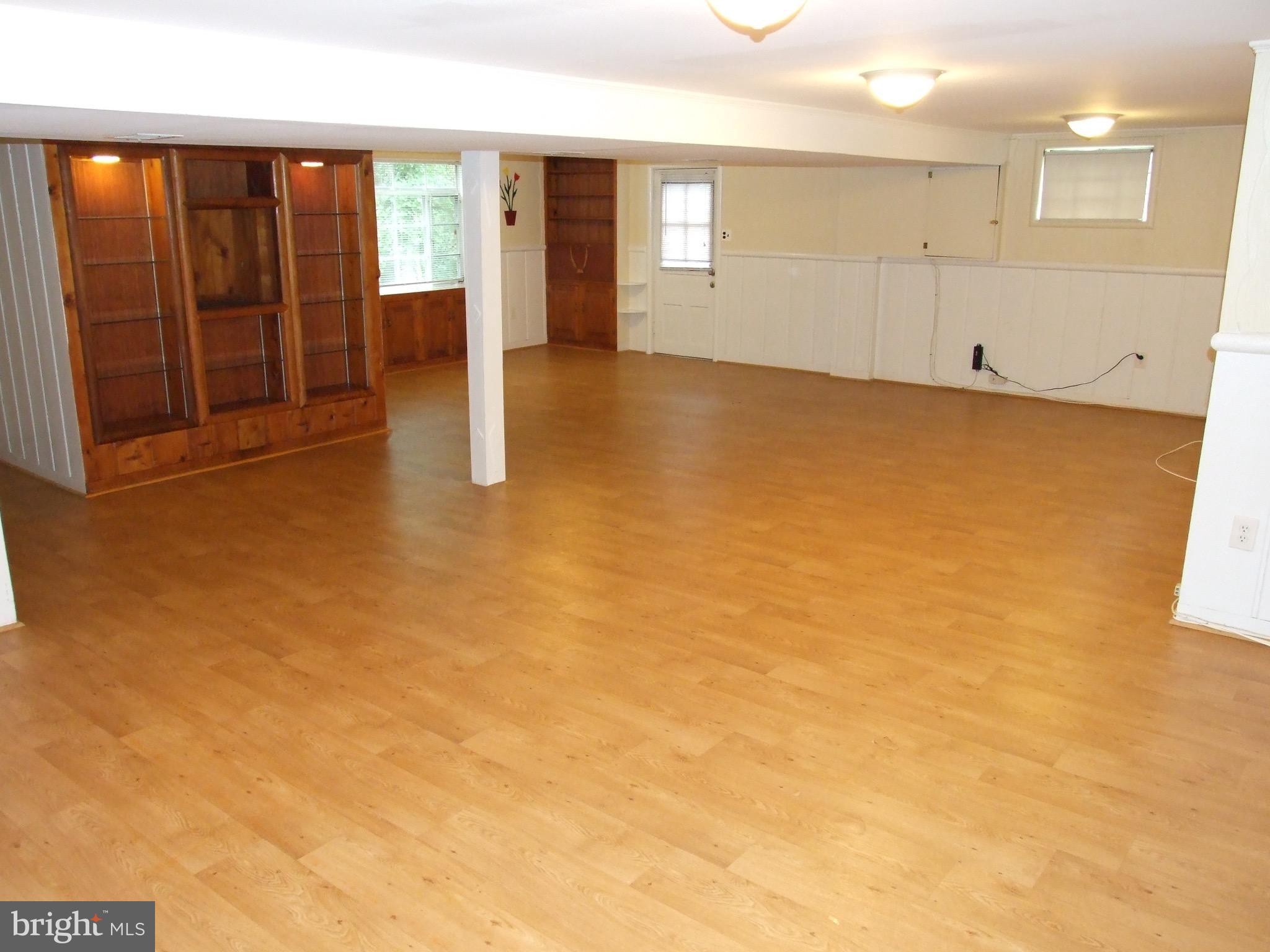 2941 Terrace Drive Chevy Chase, MD 20815 - Photo 17 of 24 wooden floor in an empty room with a window