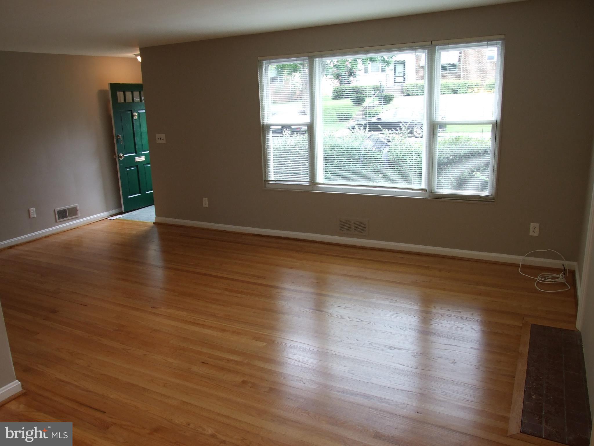 2941 Terrace Drive Chevy Chase, MD 20815 - Photo 3 of 24 a view of an empty room with wooden floor and a window