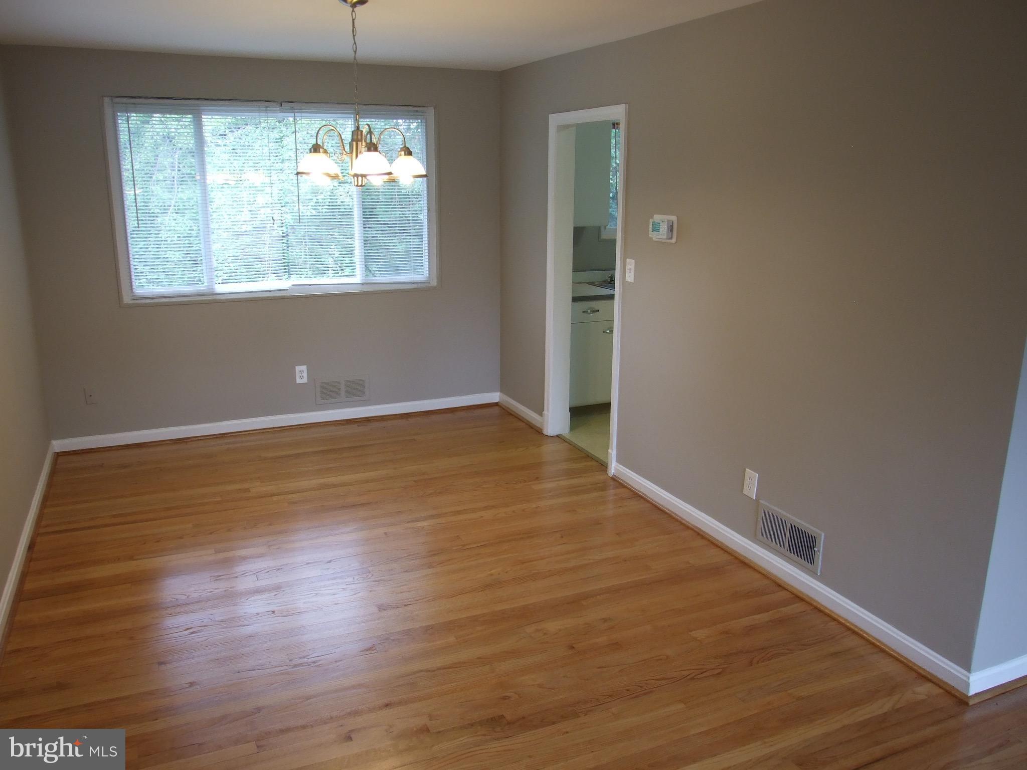2941 Terrace Drive Chevy Chase, MD 20815 - Photo 6 of 24 an empty room with wooden floor and windows