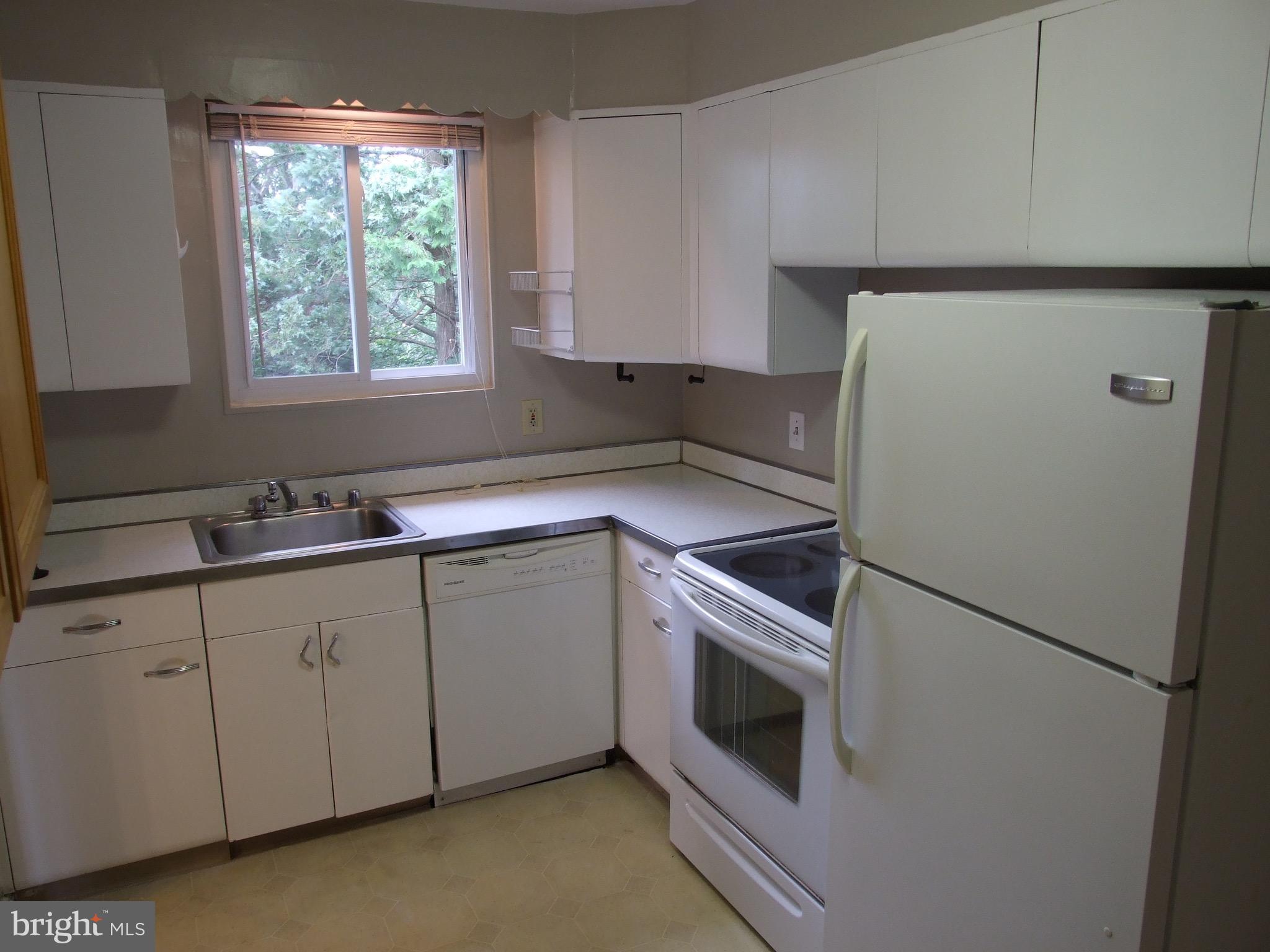 2941 Terrace Drive Chevy Chase, MD 20815 - Photo 9 of 24 a kitchen with a sink and a refrigerator
