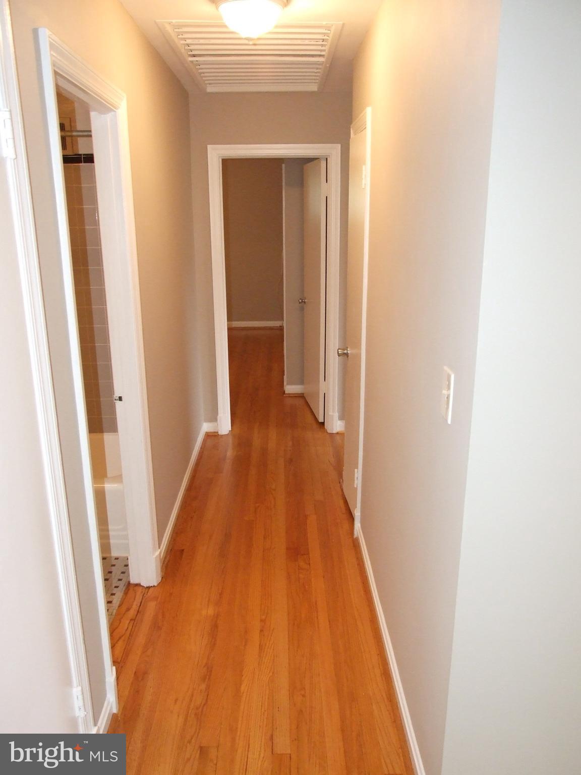 2941 Terrace Drive Chevy Chase, MD 20815 - Photo 10 of 24 a view of a hallway with wooden floor