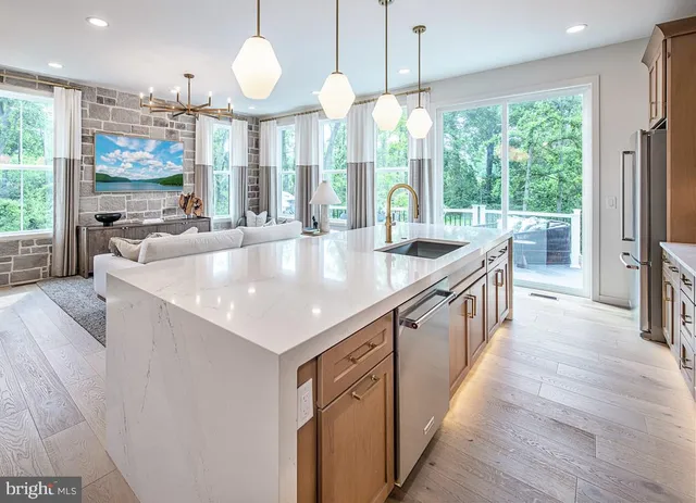 a large kitchen with kitchen island a large window in it