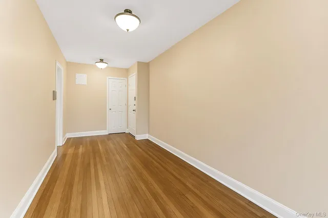 a view of room with wooden floor and fan
