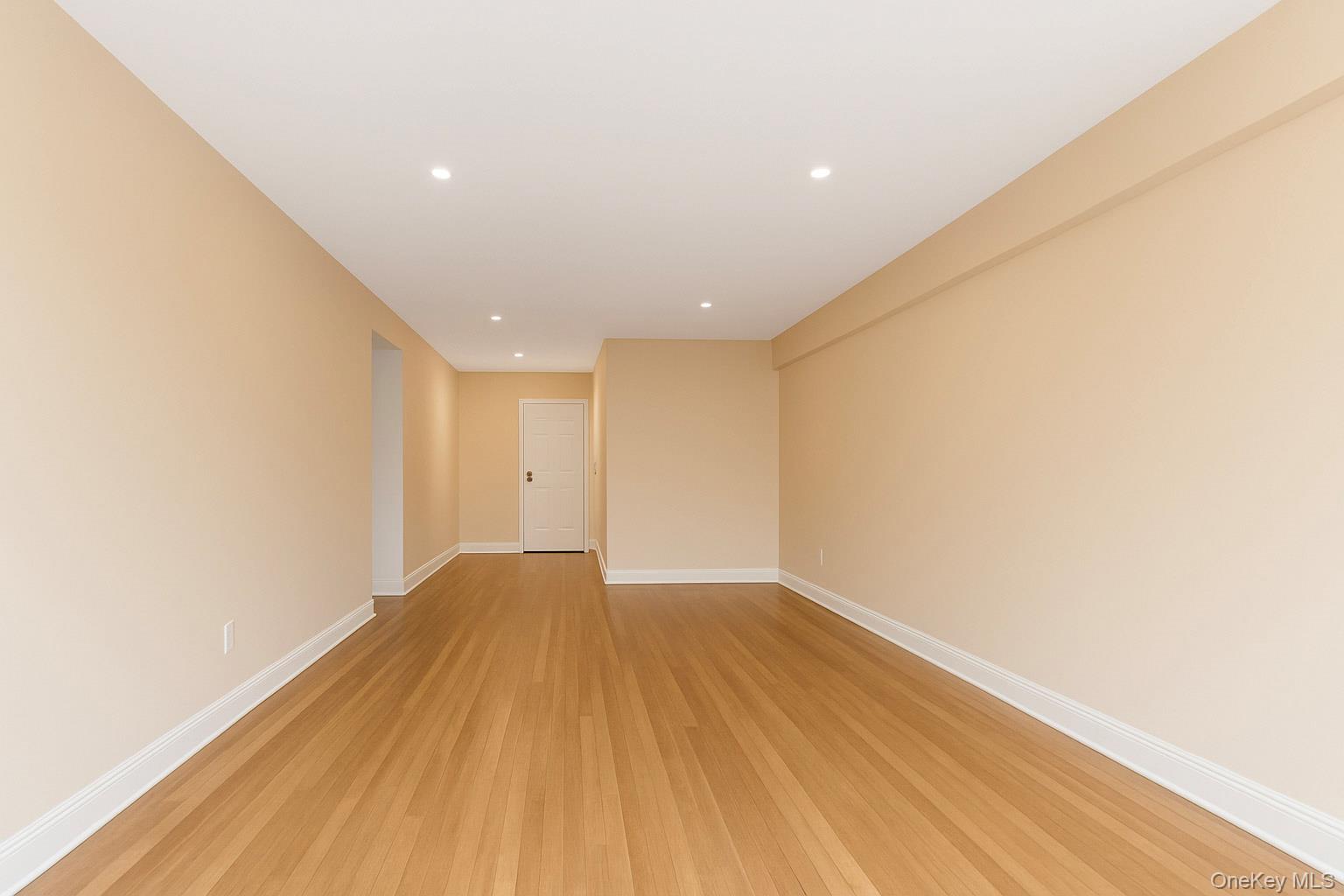 609 Palmer Road, Unit 4J Yonkers, NY 10701 - Photo 14 of 26 a view of an empty room with wooden floor