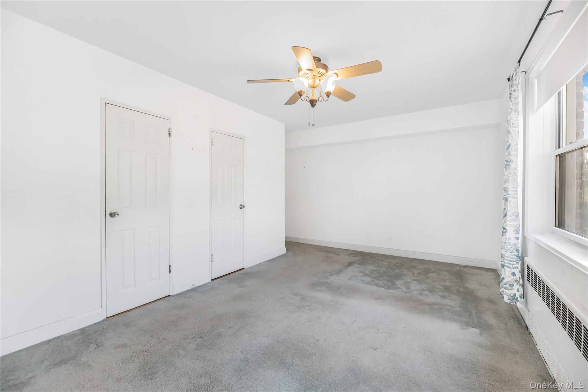 609 Palmer Road, Unit 4J Yonkers, NY 10701 - Photo 18 of 26 an empty room with a chandelier fan