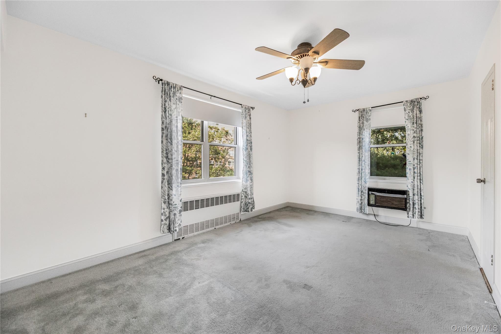 609 Palmer Road, Unit 4J Yonkers, NY 10701 - Photo 19 of 26 an empty room with windows and fan