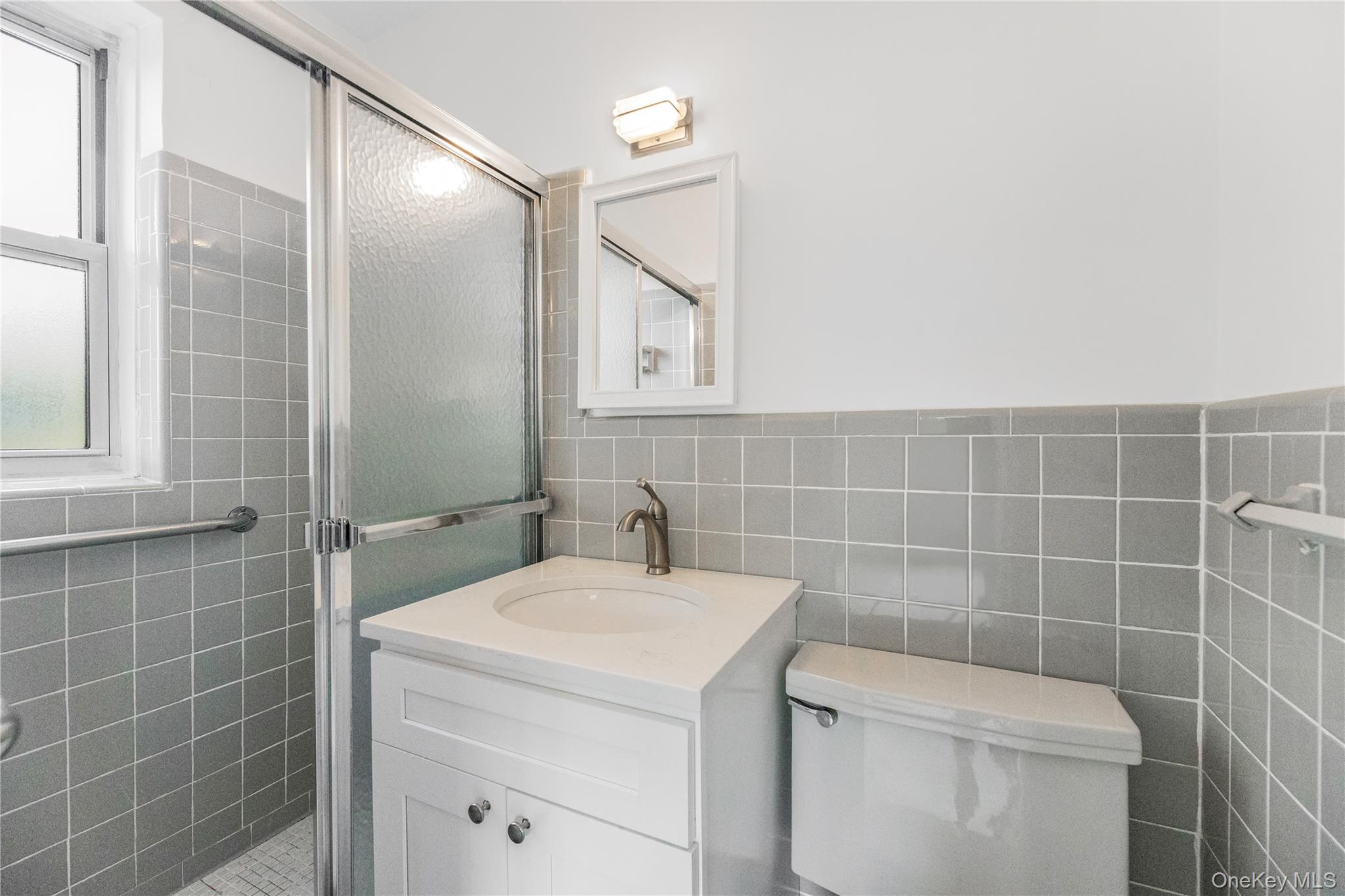 609 Palmer Road, Unit 4J Yonkers, NY 10701 - Photo 21 of 26 a bathroom with a toilet sink and mirror