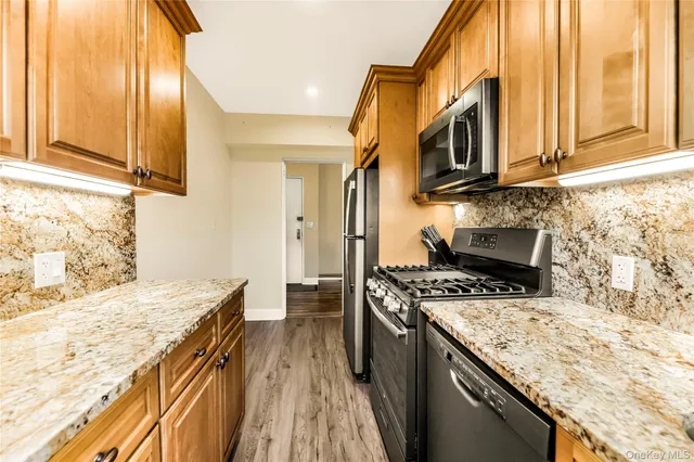 a kitchen with stainless steel appliances granite countertop a stove and a sink