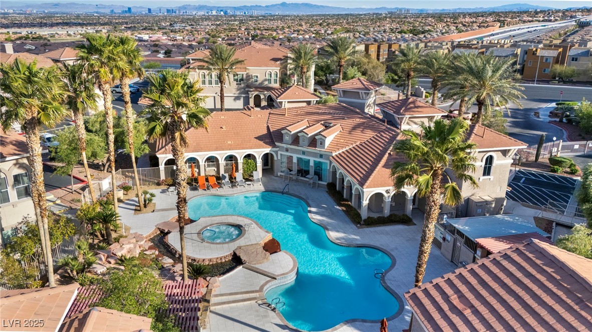 10550 West Alexander Road, Unit 2103 Las Vegas, NV 89129 - Photo 39 of 45 Community pool with a community hot tub, a mountain view, a residential view, and a patio area