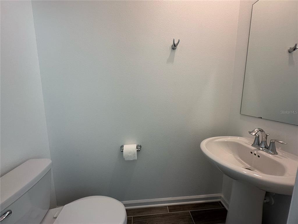 17136 Salty Dog Road Winter Garden, FL 34787 - Photo 15 of 38 a bathroom with a toilet a sink and mirror
