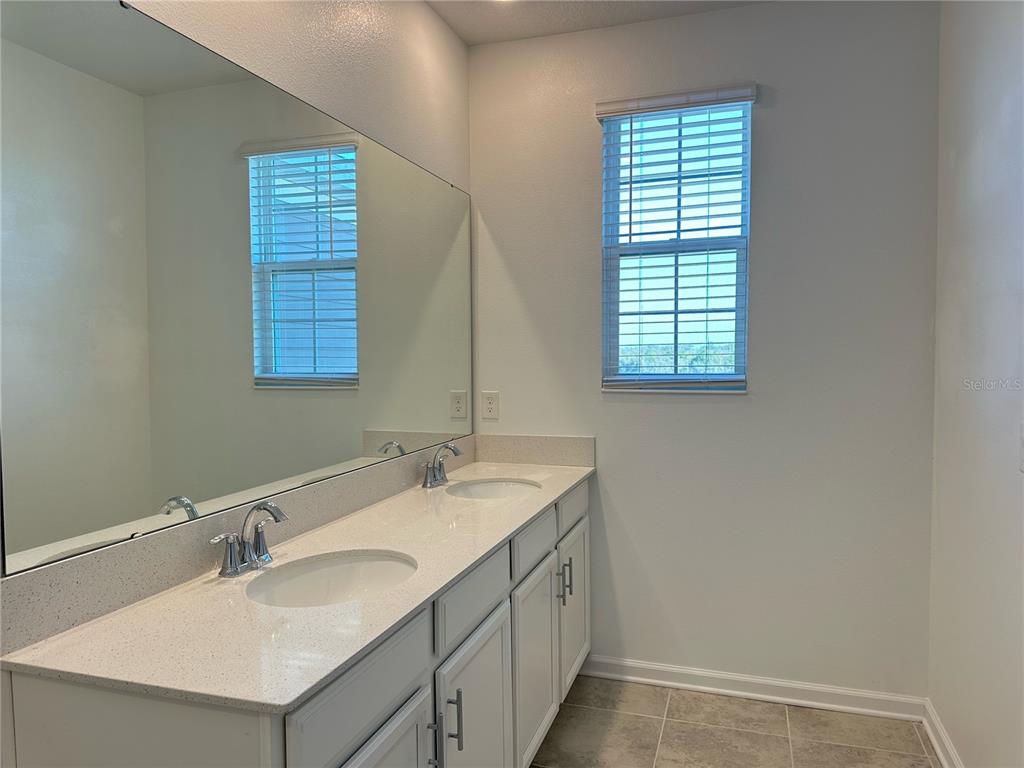 17136 Salty Dog Road Winter Garden, FL 34787 - Photo 21 of 38 a bathroom with a sink and a mirror