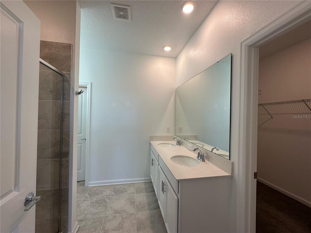 17136 Salty Dog Road Winter Garden, FL 34787 - Photo 9 of 38 a bathroom with a double vanity sink and a mirror