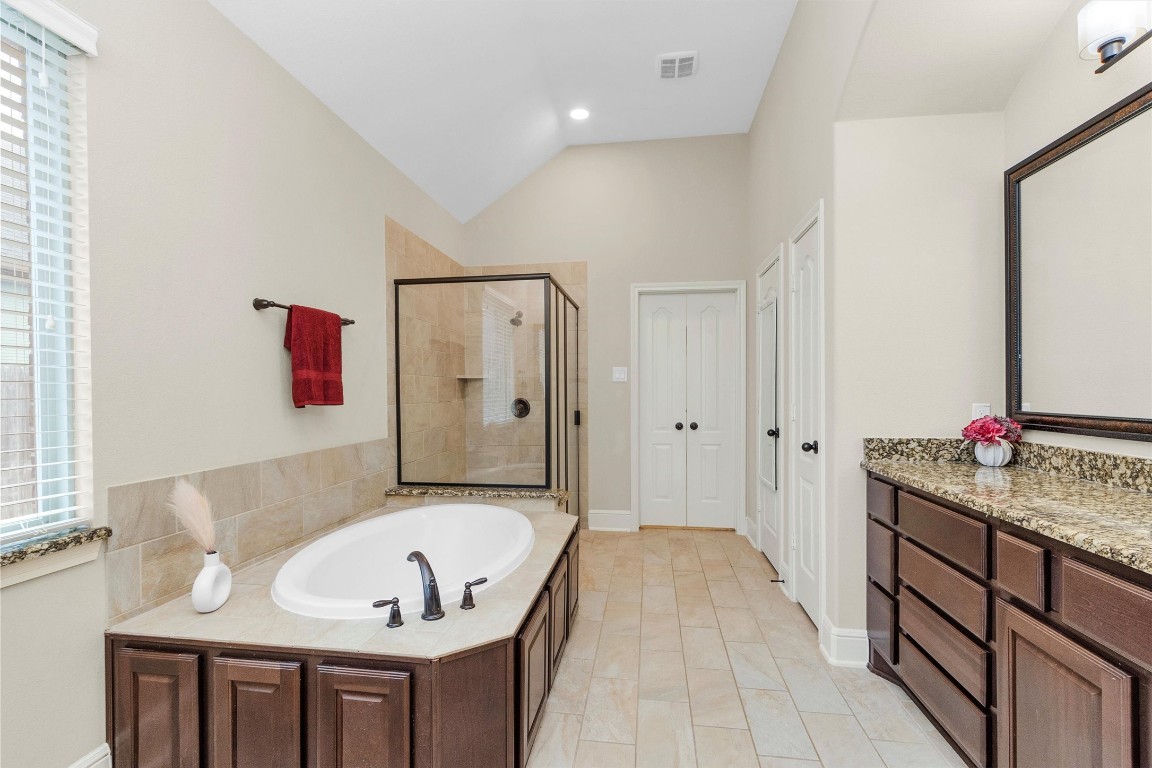 17203 Prairie Falcon Lane Conroe, TX 77385 - Photo 18 of 30 a bathroom with a tub sink and mirror