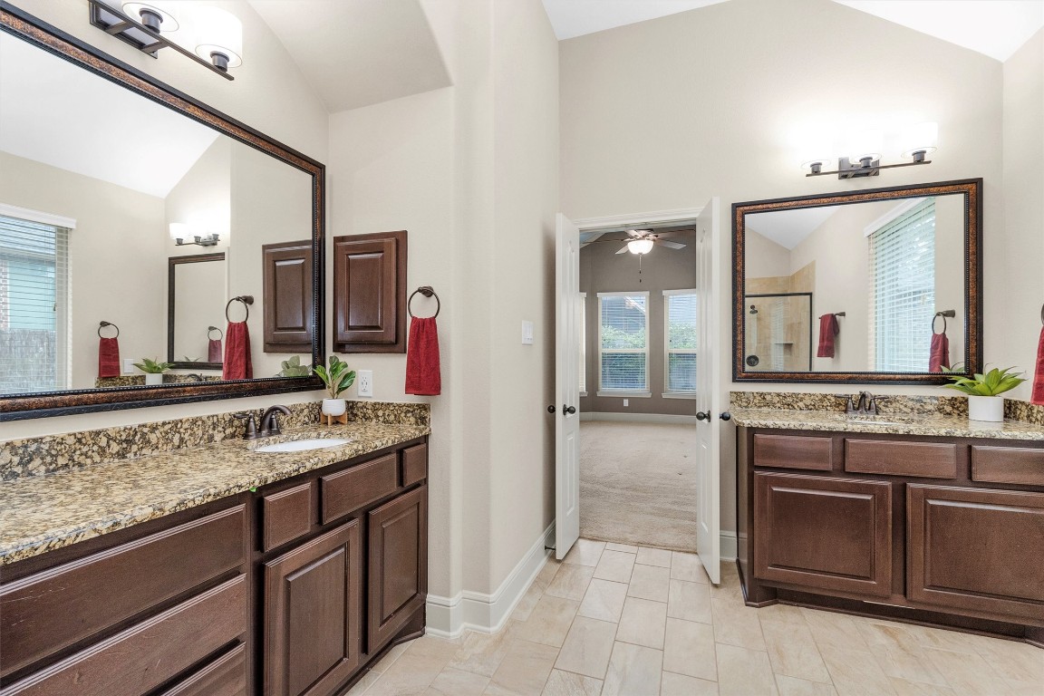 17203 Prairie Falcon Lane Conroe, TX 77385 - Photo 19 of 30 a bathroom with a granite countertop sink and a mirror