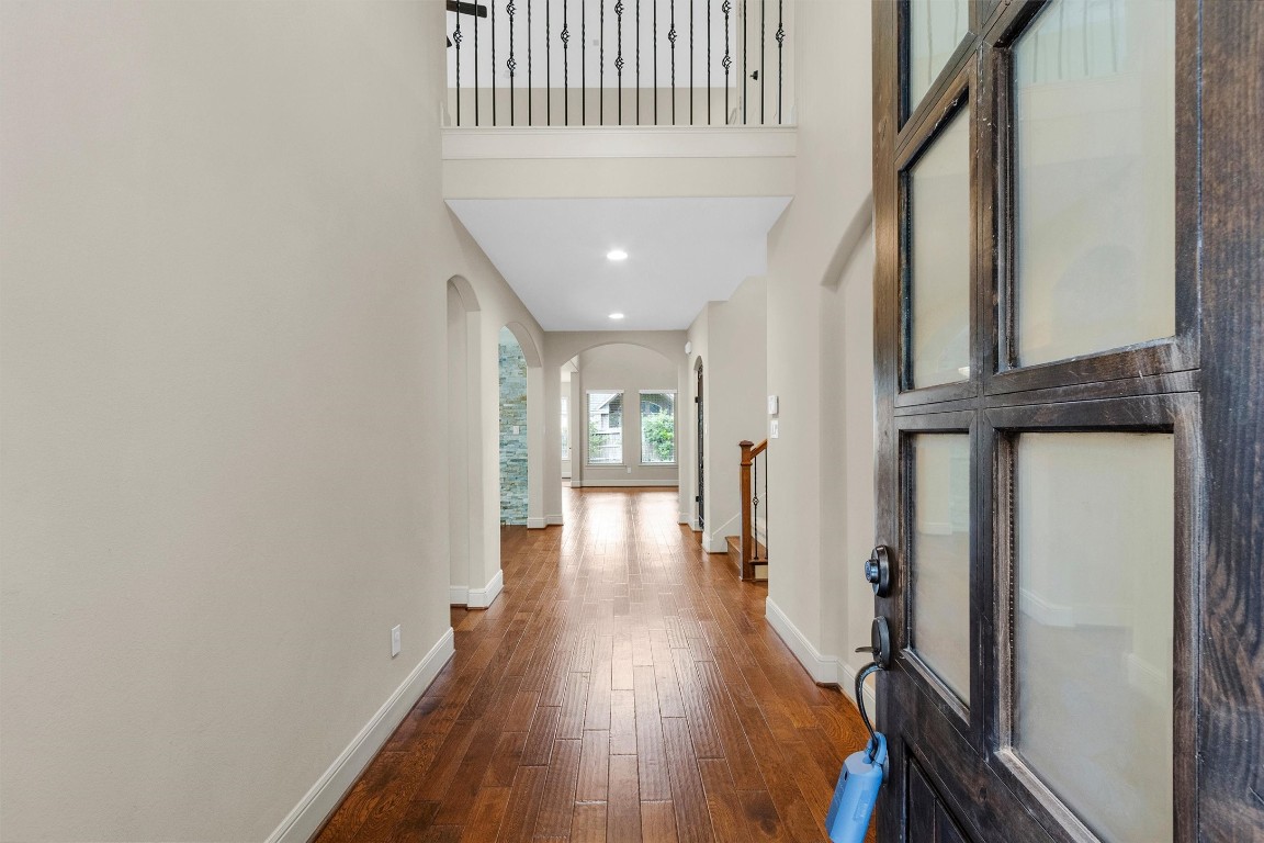 17203 Prairie Falcon Lane Conroe, TX 77385 - Photo 2 of 30 a view of a hallway with wooden floor and staircase