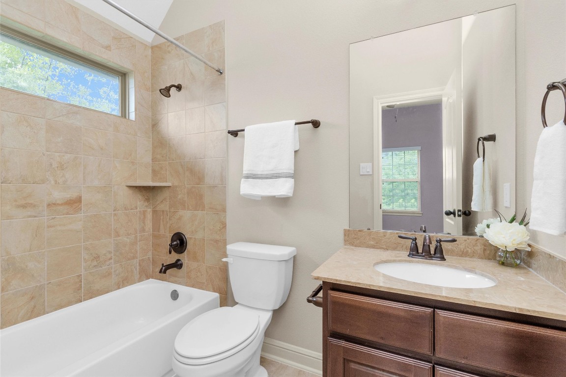 17203 Prairie Falcon Lane Conroe, TX 77385 - Photo 26 of 30 a bathroom with a sink toilet vanity and shower