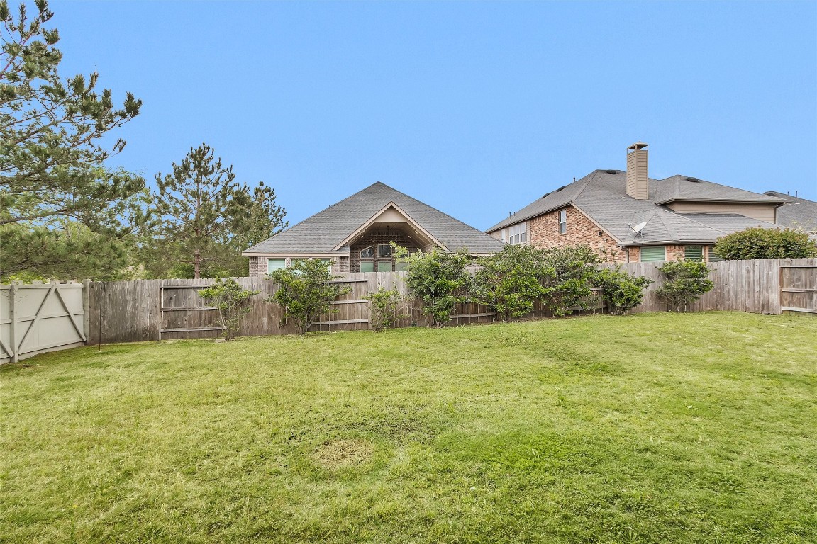 17203 Prairie Falcon Lane Conroe, TX 77385 - Photo 30 of 30 a house with green field in front of it