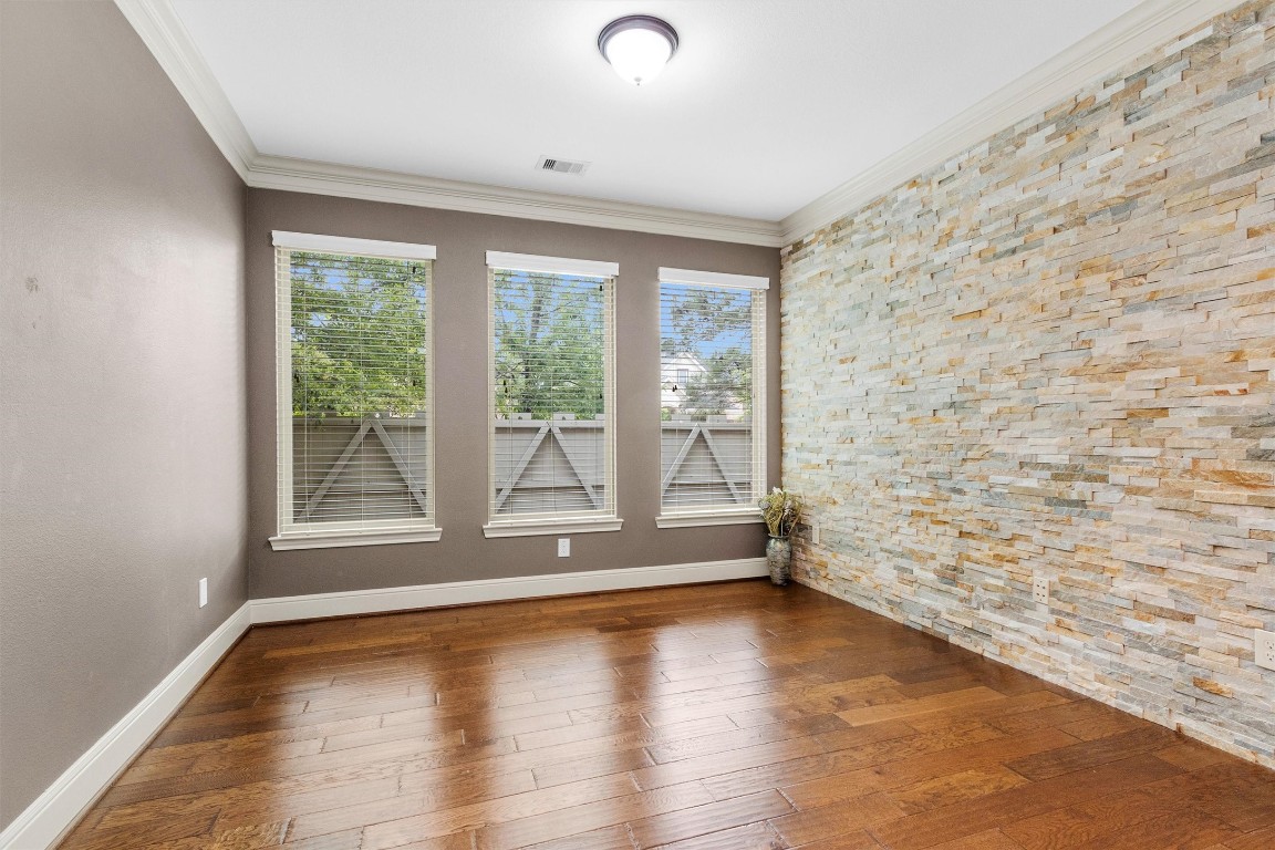 17203 Prairie Falcon Lane Conroe, TX 77385 - Photo 3 of 30 a view of empty room with wooden floor and fan