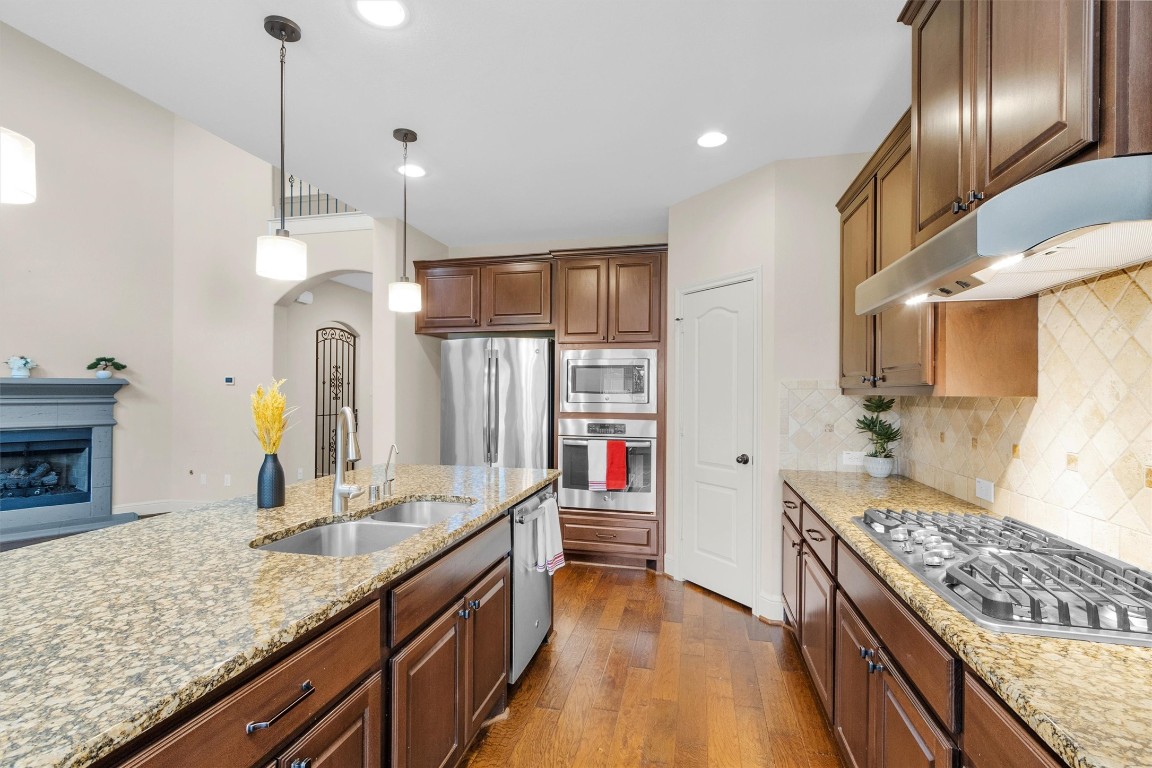 17203 Prairie Falcon Lane Conroe, TX 77385 - Photo 8 of 30 a kitchen with stainless steel appliances granite countertop a sink stove and refrigerator