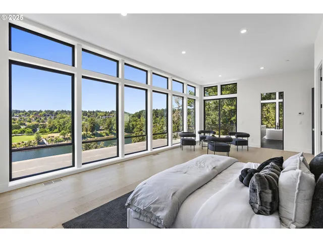 a bathroom with a double vanity sink a large mirror and a bathtub
